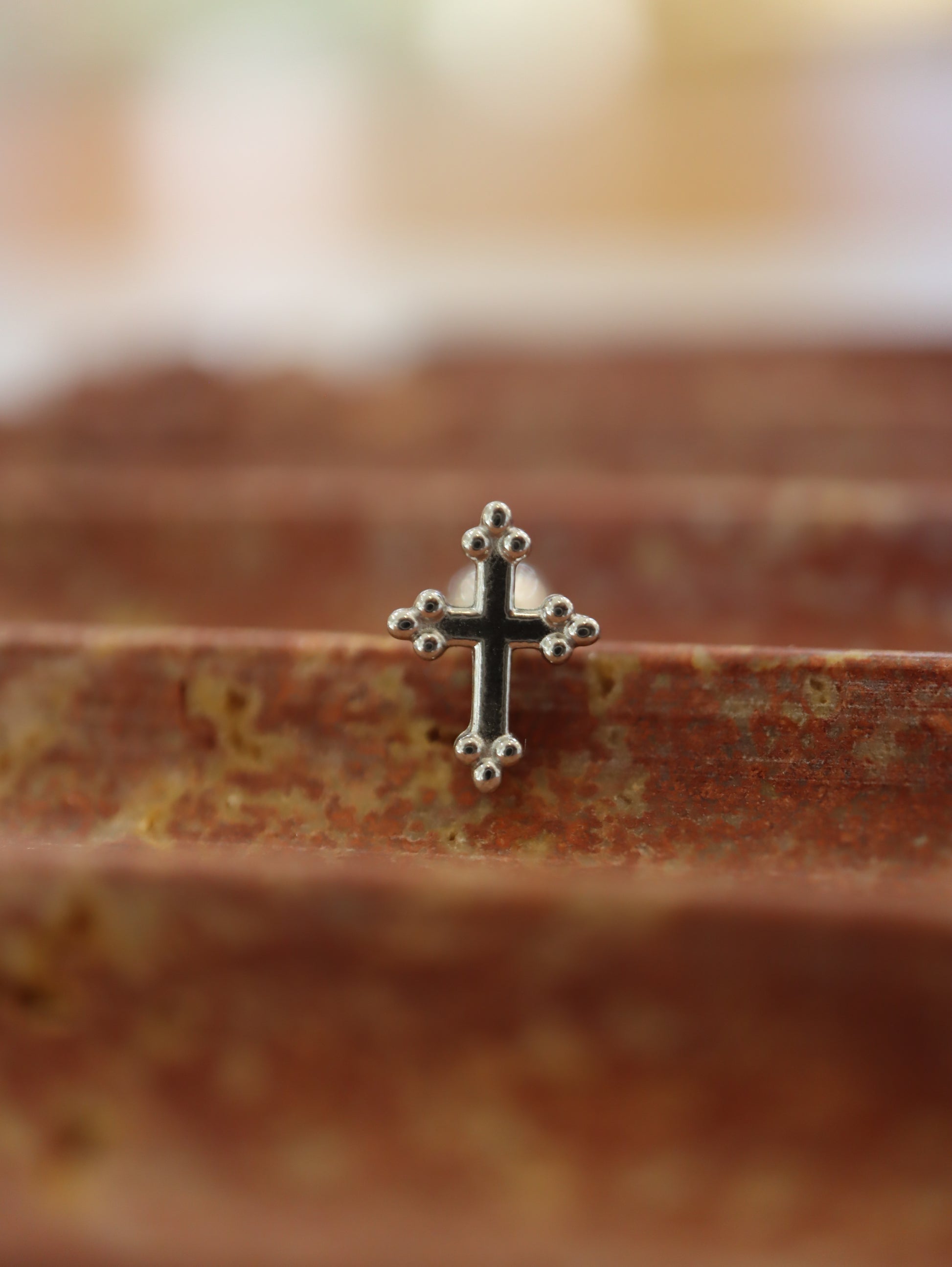 Cross surgical steel piering stud