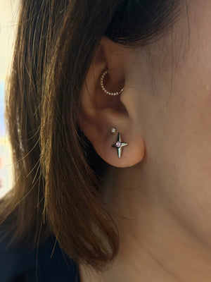 Stud cross barbell piercing