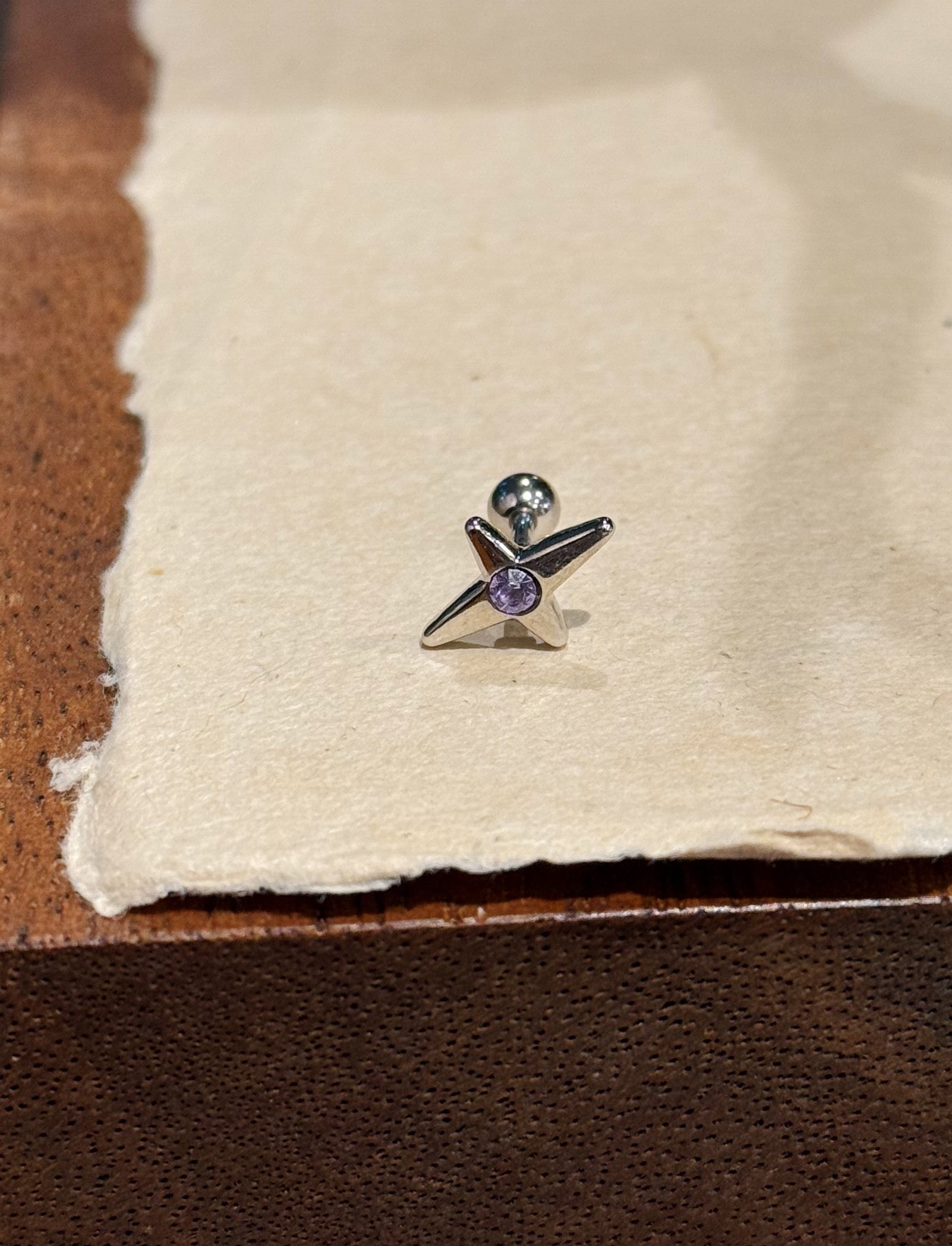Stud cross barbell piercing