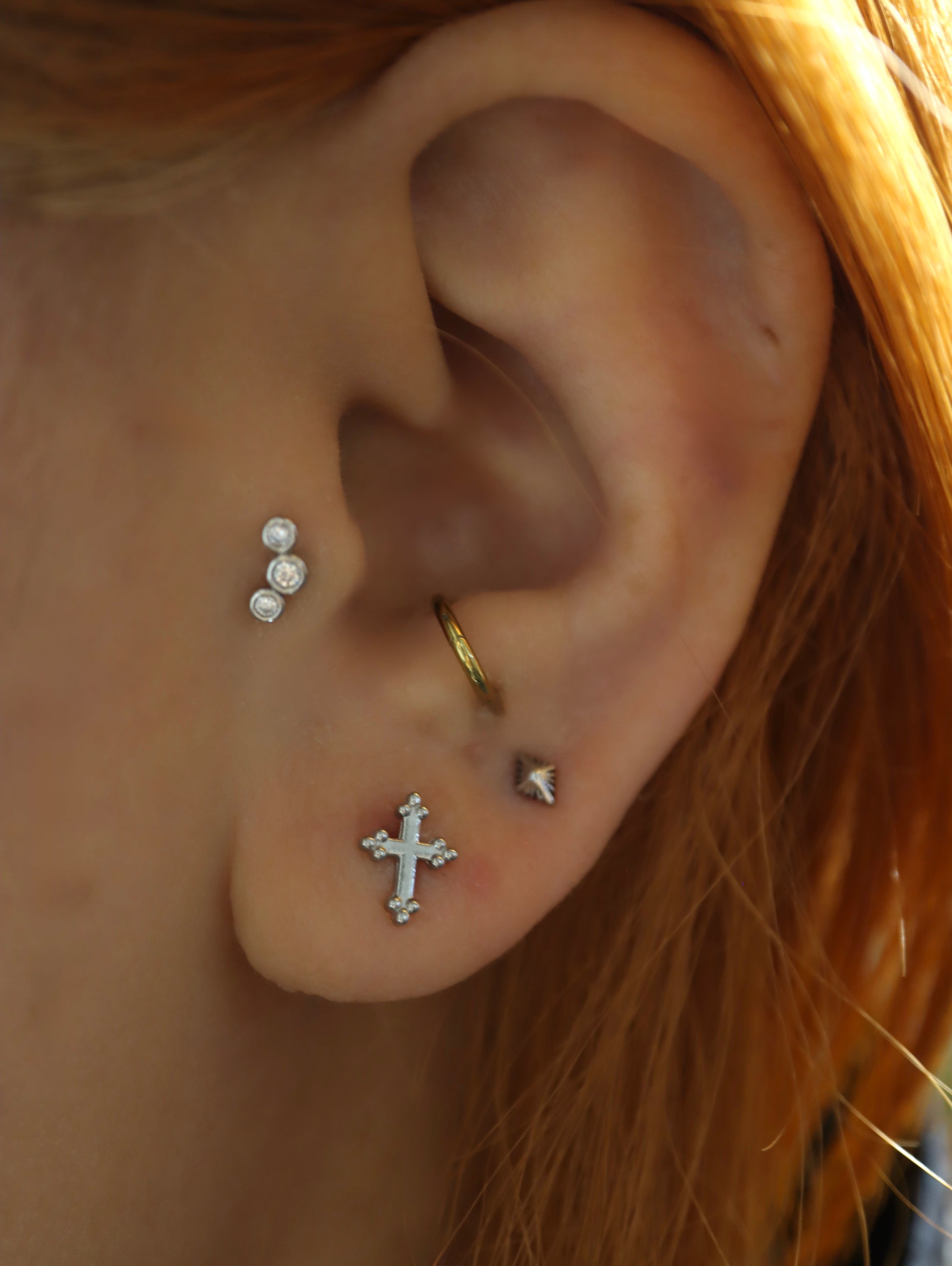 Cross surgical steel piering stud