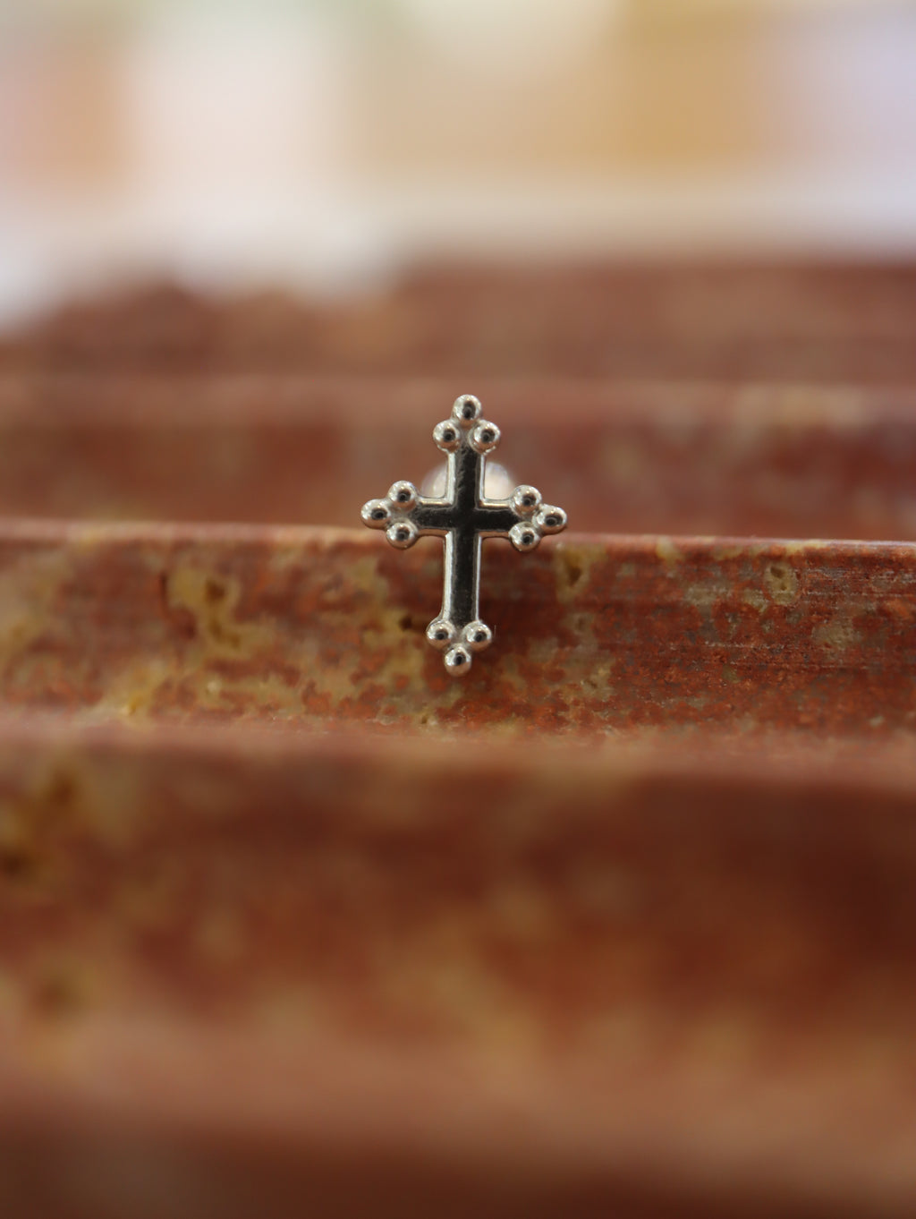 Cross surgical steel piering stud