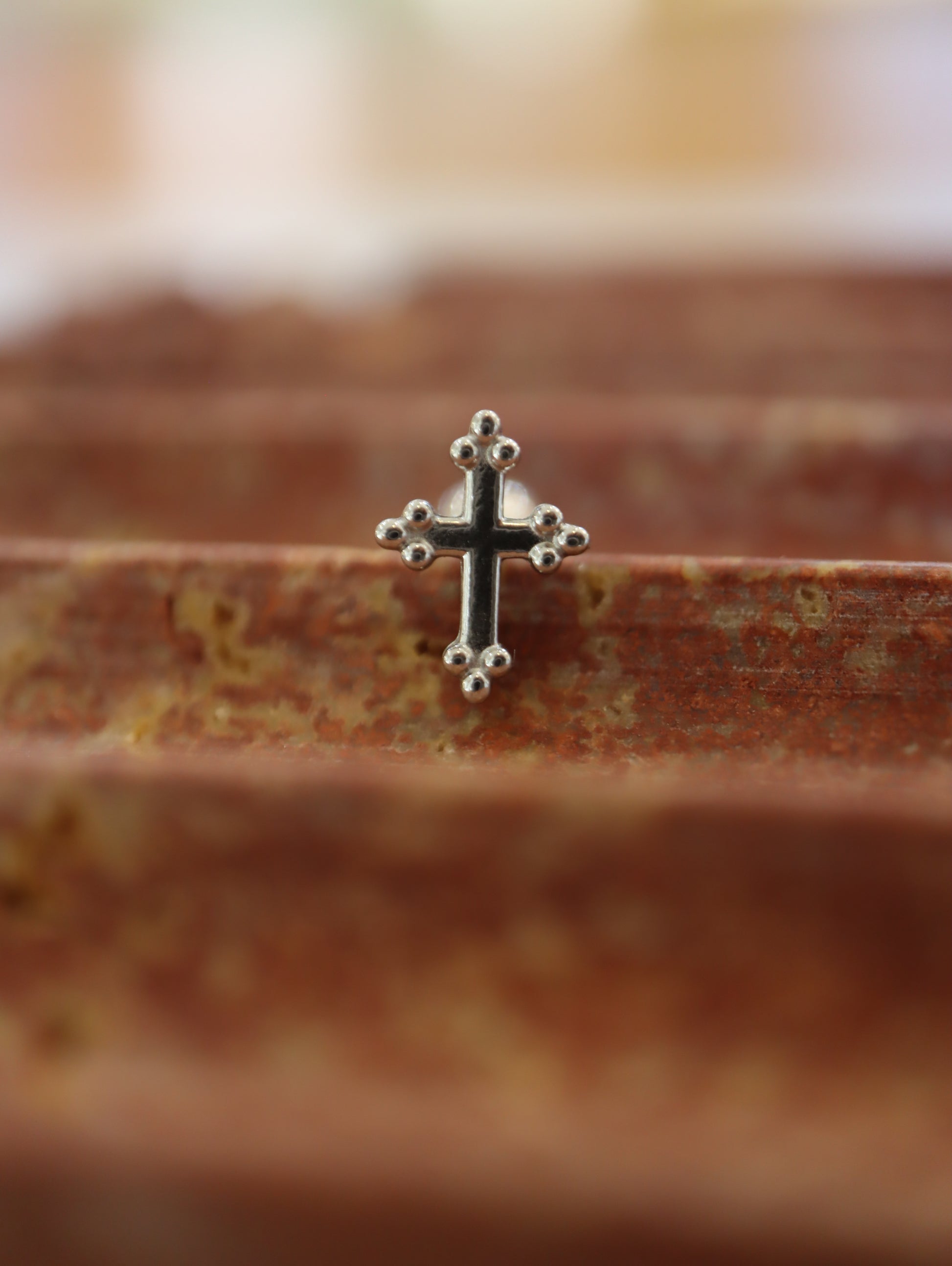 Cross surgical steel piering stud