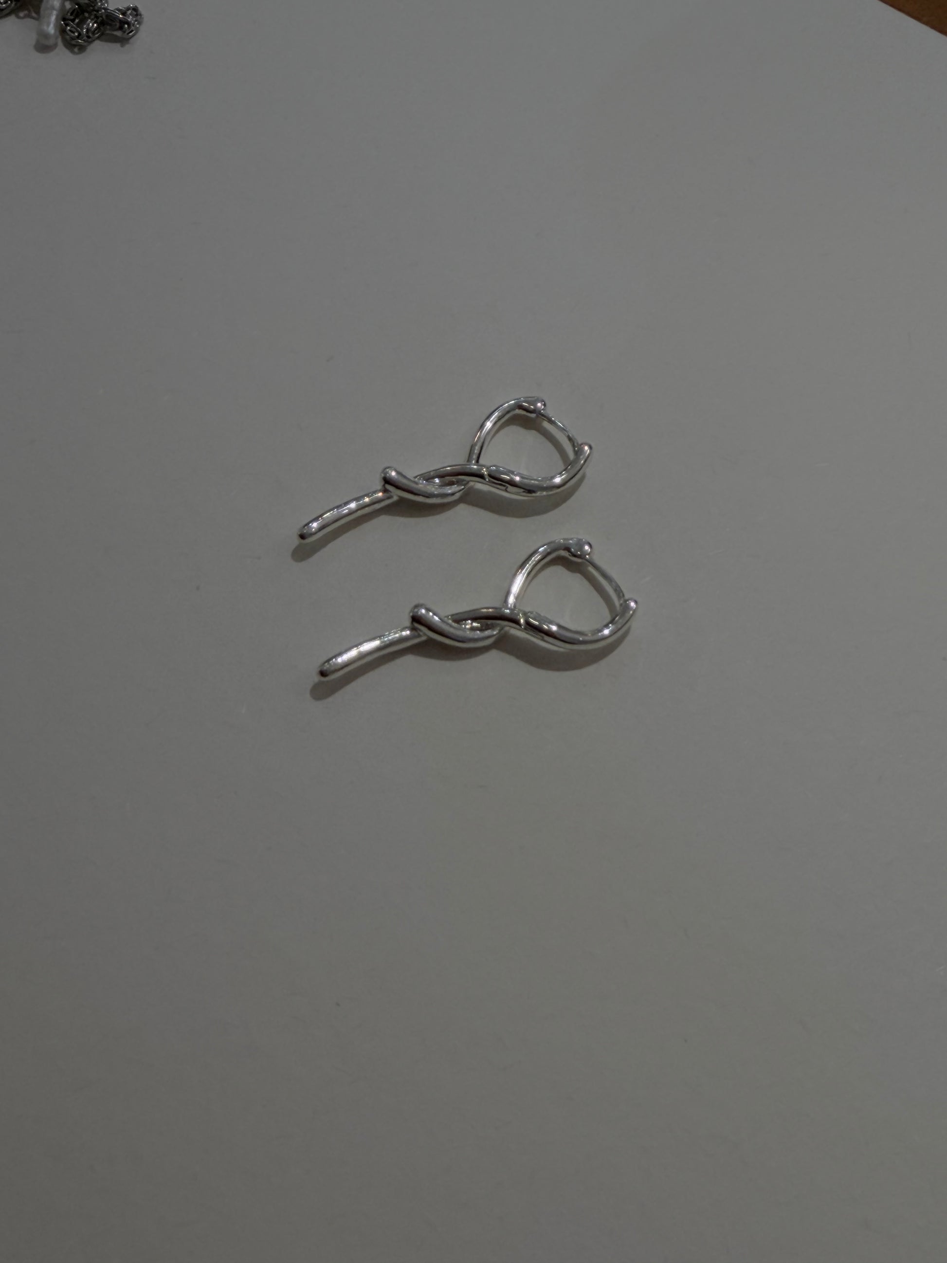 Twisted shiny silver brass earrings