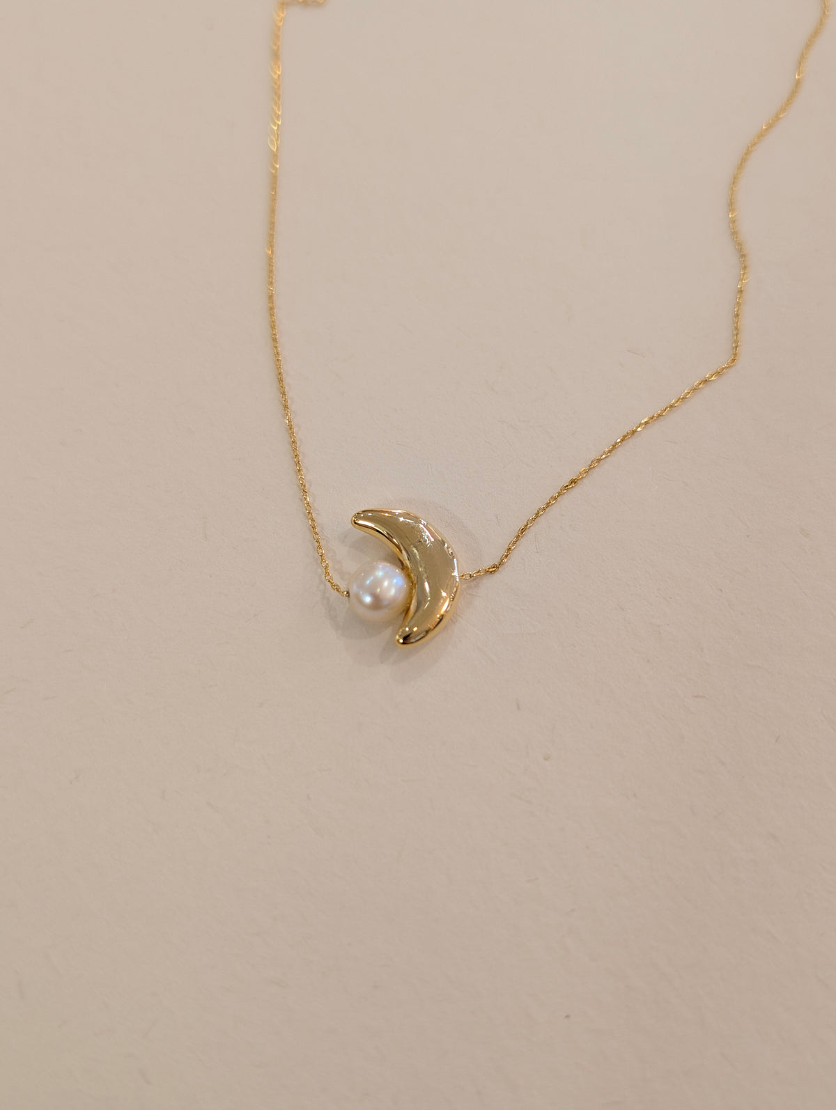 Crescent pearl brass necklace